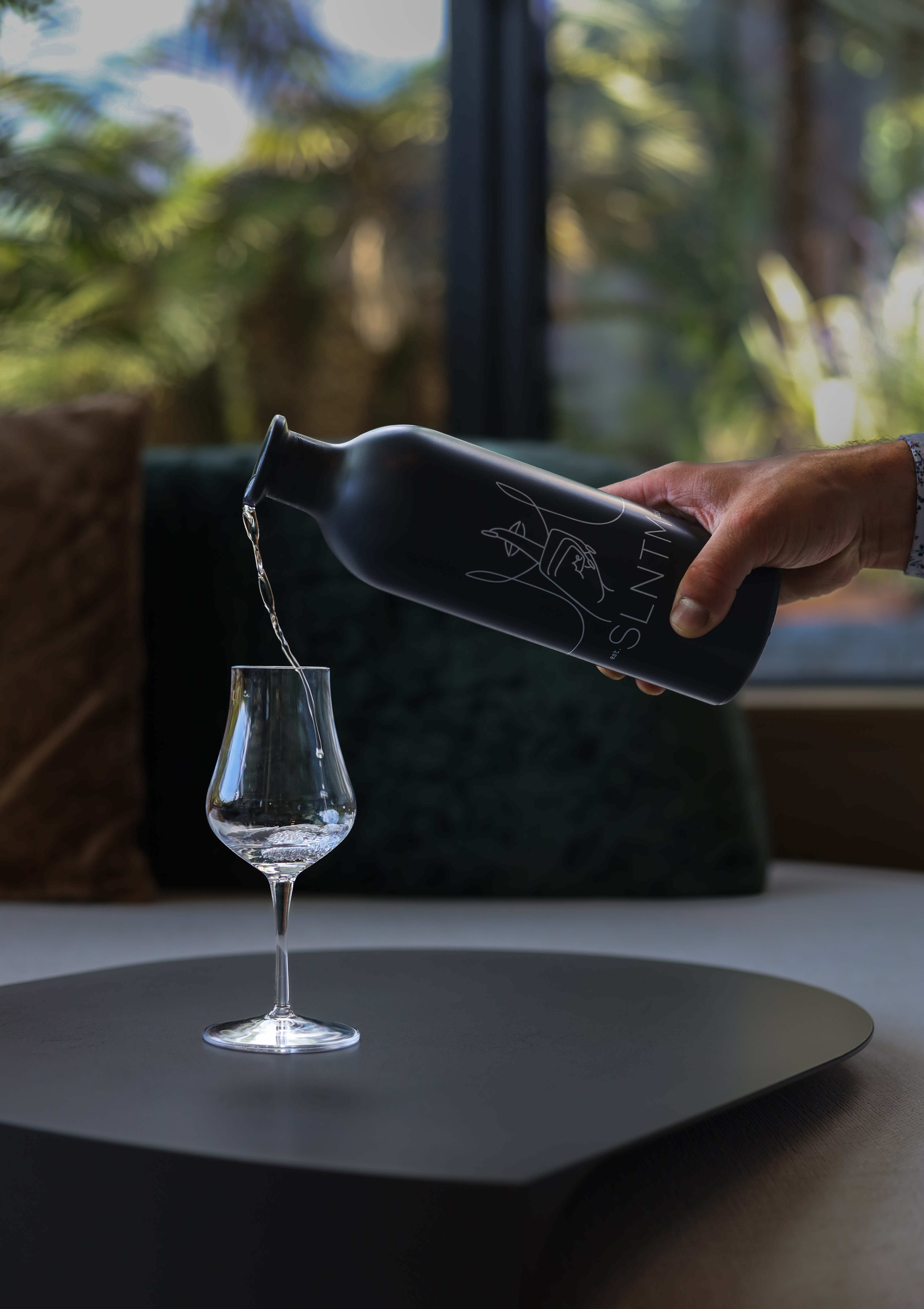 SLNTM Gin bottle on a bar counter